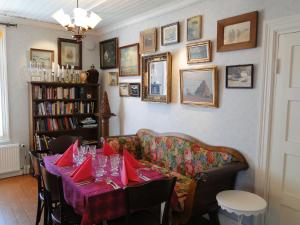 a dining room with a table and a couch at Hotel & Cafe Lanterna in Nauvo