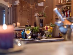 a bar with a counter with drinks and fruits on it at Hotel Jägerhof und Jagdhaus in Mayrhofen