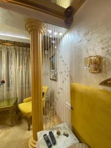 a dressing room with a mirror and a yellow chair at Стаи за гости Топ Старс Смолян in Smolyan +206 photos