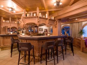 eine Bar in einem Haus mit Holzdecke in der Unterkunft Hotel Jägerhof und Jagdhaus in Mayrhofen