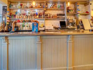 a bar in a restaurant with a counter at OYO George & Dragon Inn in Chichester