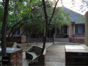 a brick house with a tree in front of it at VuguVugu - At home in Africa in Marloth Park
