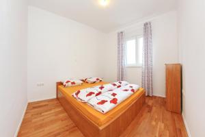 a bedroom with a bed with red pillows on it at Apartment Village Nin in Nin