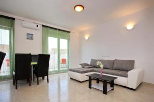 a living room with a couch and a table at Apartment Village Nin in Nin