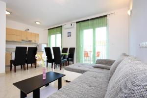a living room with a couch and a table at Apartment Village Nin in Nin