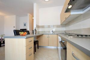 a kitchen with a counter and a stove top oven at Apartment Village Nin in Nin