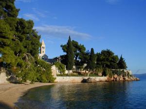 a church sitting on the shore of a body of water at Villa Jasmin in Bol