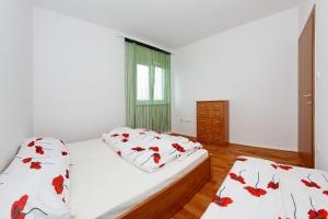a bedroom with two beds and a window at Apartment Village Nin in Nin