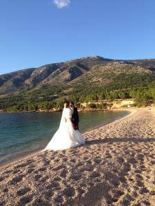 a bride and groom standing on a beach at Villa Jasmin in Bol