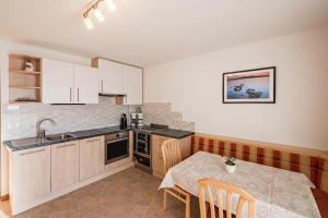 a kitchen with a table and a dining room at Apartment Pustertal in Mühlbach