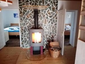 a wood stove in a room with a bedroom at chalupa PA in Frenštát pod Radhoštěm