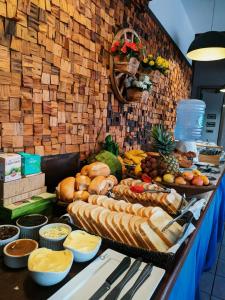 a buffet with many different types of bread and other foods at Vila Alaide Praia Hotel in Barra Velha