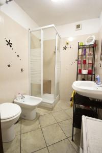 a bathroom with a shower and a toilet and a sink at For Ever Apartments in Fiumicino