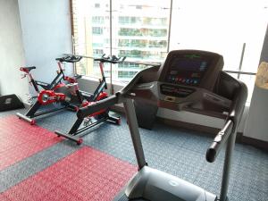 a room with a gym with a treadmill and a bike at Café Hotel Medellín in Medellín