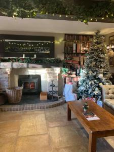 a living room with a christmas tree and a fireplace at The Blue Bell at Arkendale in Knaresborough
