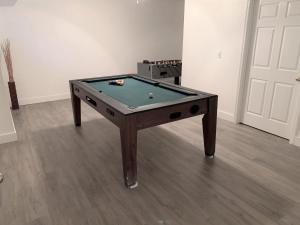 a pool table with a ball on top of it at CozyKey Vacation Rentals in Kissimmee