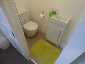 a small bathroom with a toilet and a sink at Harvey House in Chesterfield