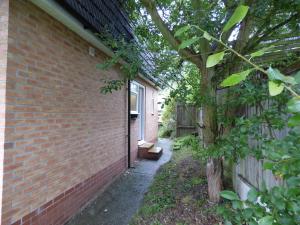 a brick building with a tree next to a door at Harvey House in Chesterfield