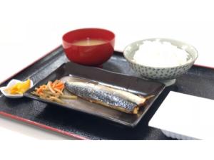 a tray with fish and carrots and a bowl of rice at Southern Village Okinawa - Vacation STAY 09978v in Kishaba