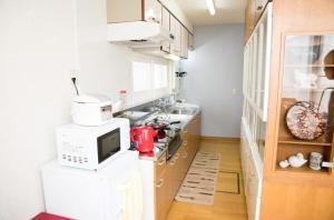 a kitchen with a sink and a microwave at STAY IN TOKIWA - Vacation STAY 16336v in Asahikawa