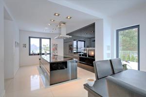 a large white kitchen with a counter and a table at Villa Serwy in Serwy