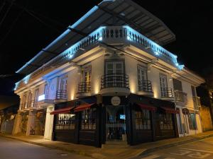a large white building with blue lights on it at Hotel Válcon in Santa Rosa de Cabal