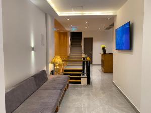 a living room with a couch and a staircase at Hotel Válcon in Santa Rosa de Cabal