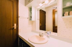 a bathroom with a sink and a mirror at Toyako minnpaku - Vacation STAY 16346v in Tōya