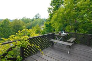 a wooden deck with a bench and a table on it at Toyako minnpaku - Vacation STAY 16346v in Tōya