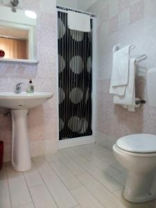 a bathroom with a toilet and a sink and a shower at Hotel Niagara in Caselle Torinese