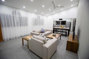 a living room with a white couch and a table at Ocean Palms Residences in Cabarete