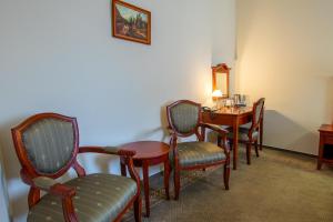 a room with a table and chairs and a desk at Hotel Giovanni Giacomo in Teplice