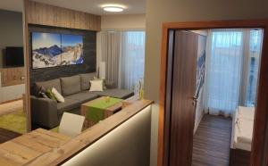 a living room with a couch and a table at Apartmán Hrebienok Rezort A307 in Starý Smokovec