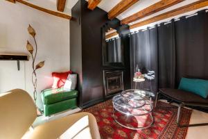a living room with a glass table and a couch at Le Balcon du Palais de l'Isle - Aprtement 4 with stunning views in Annecy