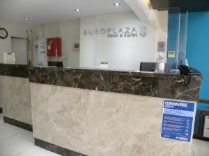 a lobby of a hotel with a reception counter at Europlaza Hotel & Suites in Buenos Aires
