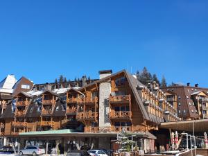 a large building with a lot of balconies on it at Apartment B331 - Aparthotel Vucko Private host in Jahorina