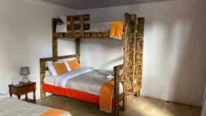 a bedroom with two bunk beds in a room at Hotel Your House in Alajuela