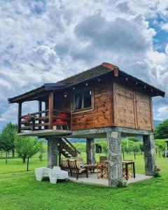 a tree house with a deck on top of it at Drinska laguna in Banja Koviljača