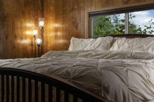 a bed with white sheets and a window in a room at The Blanchard Guest Home in Dundee