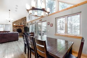 a dining room and living room with a table and chairs at Elegant Pine in South Lake Tahoe