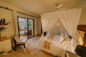 a bedroom with a bed with a ceiling fan at Tentaciones Hotel & Lounge Pool - Adults Only in Zihuatanejo