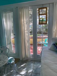 a bedroom with a bed and a view of a balcony at Ms. Maggie's South Country Inn in Daytona Beach