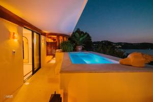 a swimming pool on the side of a house at Tentaciones Hotel & Lounge Pool - Adults Only in Zihuatanejo
