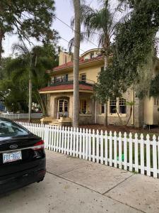 una staccionata bianca di fronte a una casa di Ms. Maggie's South Country Inn a Daytona Beach