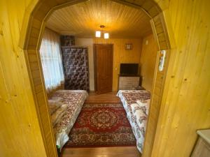 a room with two beds in a small room at Міні Котедж in Verkhovyna