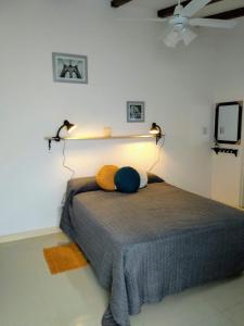 a bedroom with a bed with two lights on the wall at Monoambiente confortable a pasos de Bv. Oroño in Rosario