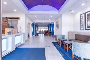a lobby of a hospital with chairs and tables at Holiday Inn Express Hereford, an IHG Hotel in Hereford