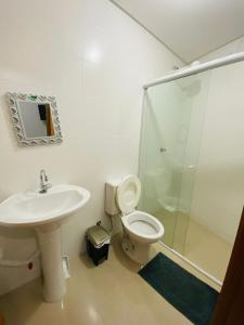a bathroom with a sink and a toilet and a shower at Pousada Wall Paraíso in Itapema +33 photos