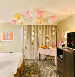 a room with a bed and a table with balloons at GreenTree Inn & Suites Los Angeles - Alhambra - Pasadena in Alhambra