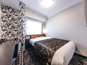 Postel nebo postele na pokoji v ubytování APA Hotel Shinagawa Togoshi Ekimae